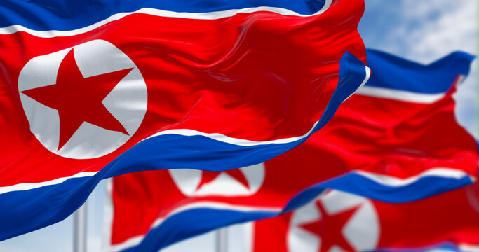 Close-up of North Korea national flags waving in the wind on a clear day