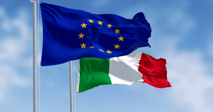 Italy and European Union flags waving on a clear day