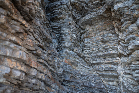 Close-up view of layered sedimentary rock strata on a cliff face