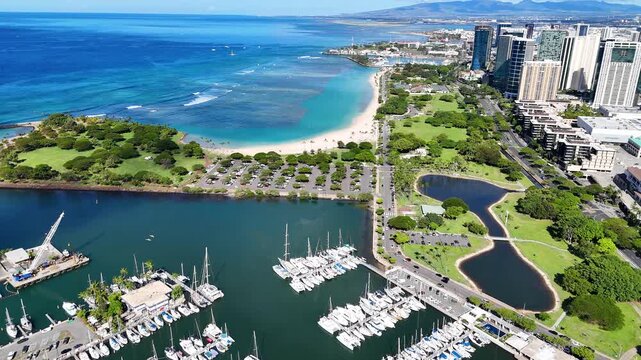 Aerial drone view of Ala Wai Boat Harbor, Magic Island, Ala Moana Beach Park, and Honolulu skyline in Hawaii