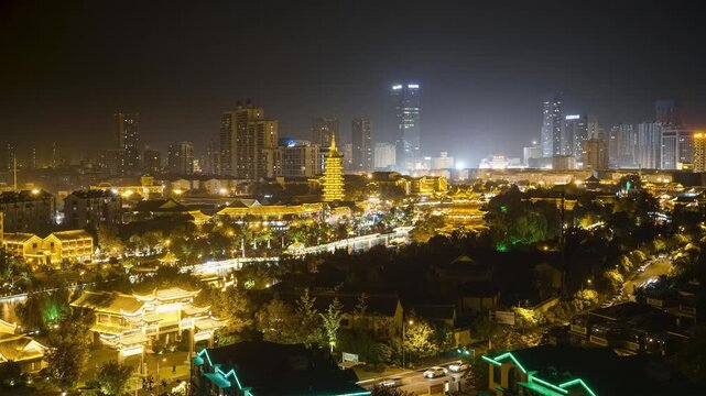 Night view of a city skyline with traditional Chinese pagoda and modern buildings in Xi an, China