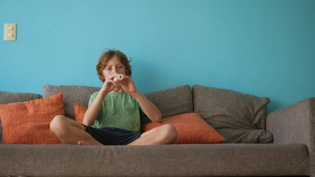 A little boy learns to play the flute at home, practicing with focus and enthusiasm in a cozy, warm setting. A charming scene of early musical exploration, creativity, and childhood growth.