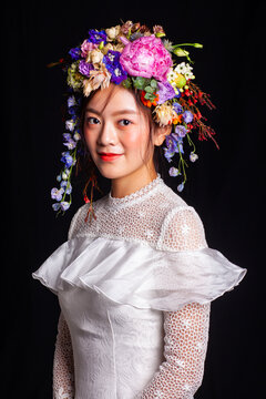 Portrait photography featuring a "forest-style" fresh flower crown and a white tulle dress.