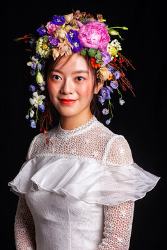 Portrait photography featuring a "forest-style" fresh flower crown and a white tulle dress.