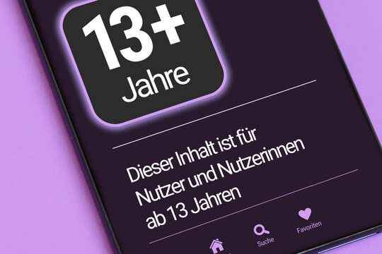 Close up of German 13+ years label with text "This content is for users aged 13+ years" on smartphone screen as social media age restriction concept