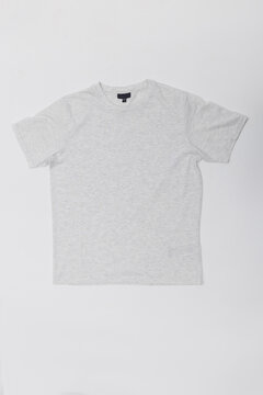 Front view flat lay of a plain light grey heather t-shirt isolated on a white background. Minimalist cotton short-sleeve shirt mockup, ideal for branding, apparel catalog, and design template.