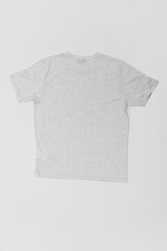 Back view flat lay of a plain light grey heather t-shirt isolated on a white background. Minimalist cotton short-sleeve shirt mockup, ideal for branding, clothing catalog, and apparel design.