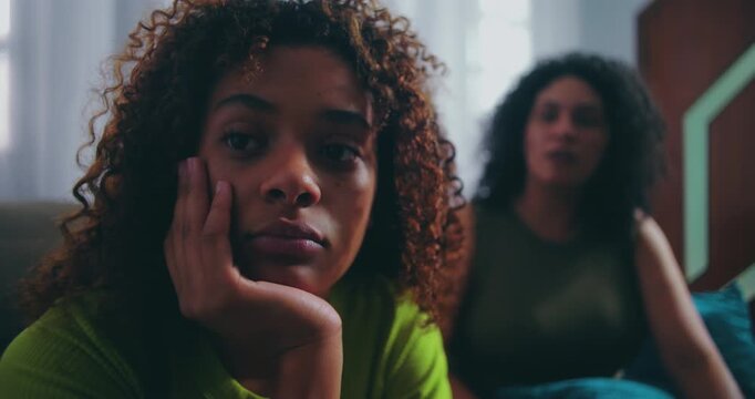 Frustrated mother talking to teenage daughter who is ignoring her, highlighting family conflict, parenting challenges, and emotional disconnection, African descent