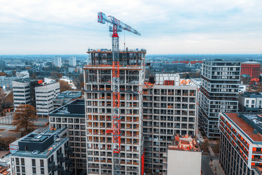 Modern building under construction with urban crane