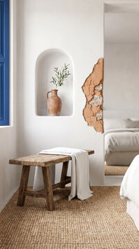 Terracotta jug niche beside exposed stone patch and rustic linen draped bench