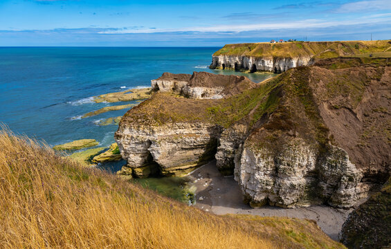 Panoramic view of the spectacular chalk cliffs, sea caves and rocky shoreline at Flamborough Head, East Yorkshire, England, overlooking the deep blue North Sea on a sunny summer day in August.