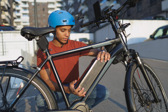 Man changing battery on his electric bicycle