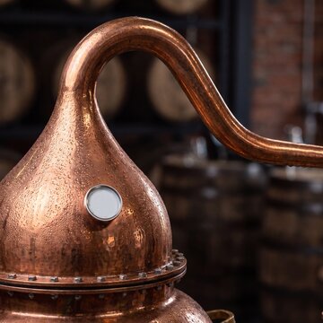Macro view of wet copper distillation still in traditional craft brewery