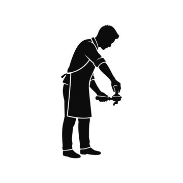 A male barista tamping coffee grounds into a portafilter
