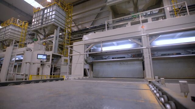 Modern Industrial Factory Interior with Automated Machinery and Conveyor Systems