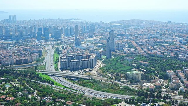 Aerial view of urban landscape featuring highways, residential buildings, and green spaces in a bustling city environment in Istanbul, Turkey 