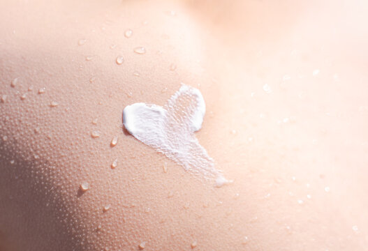 Close-up of Heart shaped SPF cream on wet skin