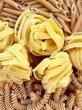 Full frame Close-up overhead view of assorted uncooked pasta including penne, fusilli and fettuccine