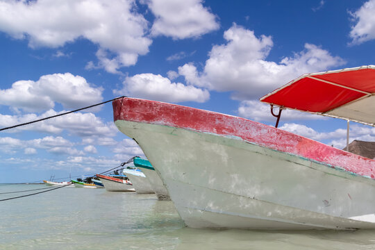 Close-up of a row of fishing boats anchored in the shallow waters of the Gulf of Mexico, Celestun, Yucatan Peninsula, Mexico