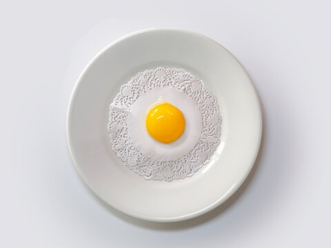 Overhead view of a conceptual fried egg on a plate