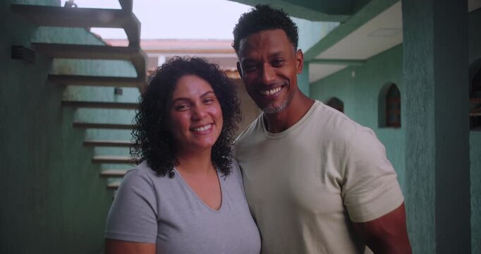 Close-up of cheerful African couple standing in a hallway, radiating love and unity, celebrating a moment of happiness and togetherness
