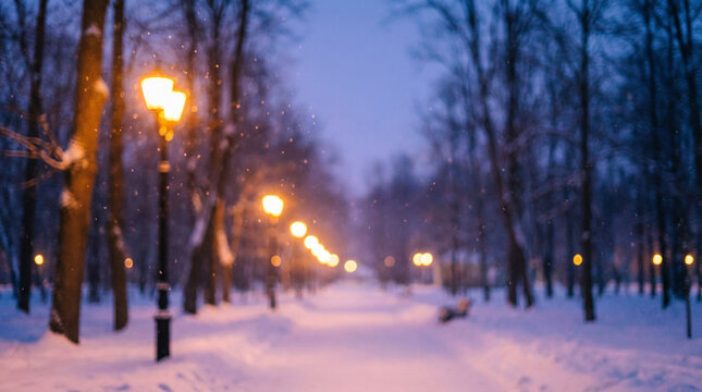 Beautiful snow covered winter park pathway illuminated by glowing street lamps at twilight perfect for magical seasonal holiday backgrounds
