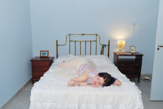 Young person resting on their bedroom with vintage decor