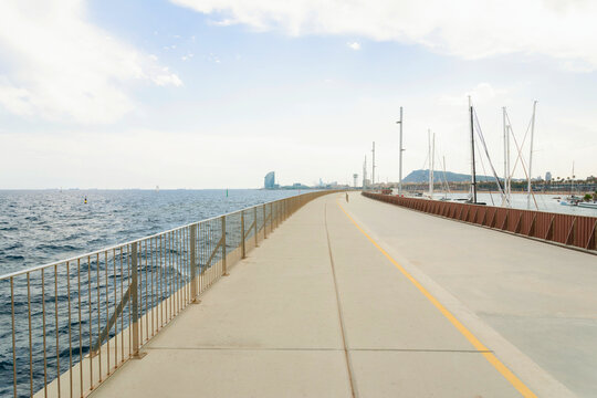 Walking Path by the Sea With Boats in the Background at Barcelona