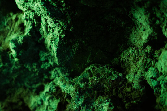 Rough green rock wall showing natural texture