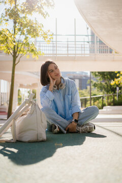 A woman having a break by sitting in an urban area