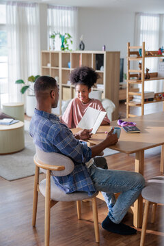 A father and daughter sharing a book at home