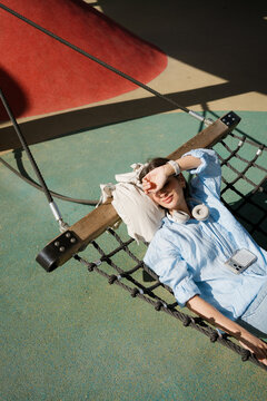 Woman Lying in Hammock Relaxing in Sunshine