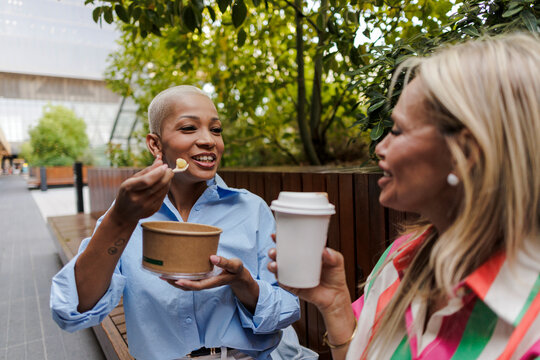 Diverse women enjoying lunch together outdoors