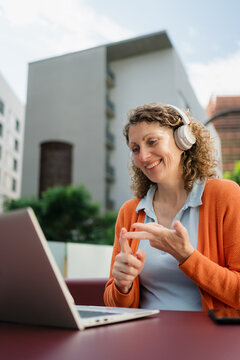 Woman making a call on her laptop in public area