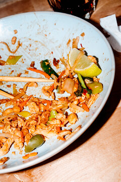 a close-up of the remains of a chicken pad thai meal