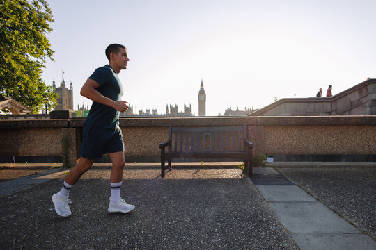 Young man running in London near Big Ben