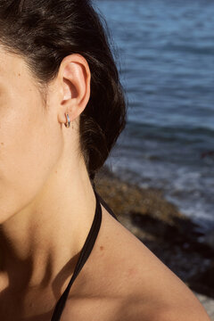 Silver hoop earring on female ear