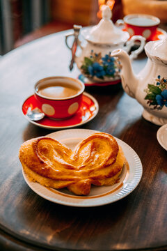 Coffee and pastry on a table in a cozy cafe setting