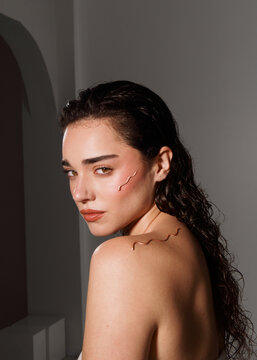 Model Poses With Artistic Body Paint in Studio Setting