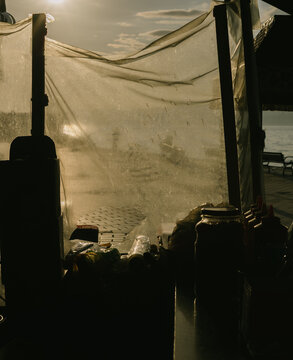 Food Stall by the Waterfront During Sunset