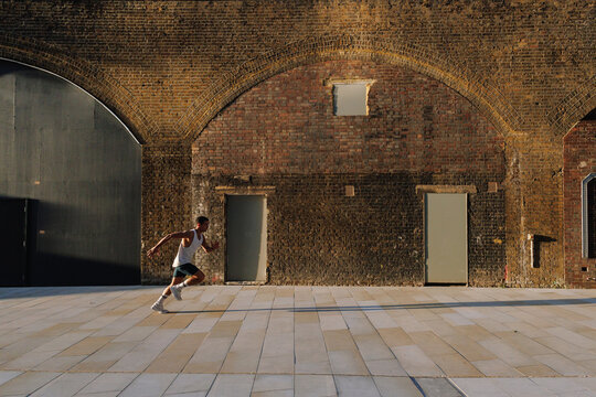 Young man running for fitness in urban environment