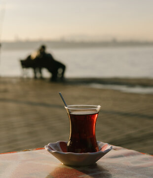 Enjoying Tea by the Water as the Sun Sets