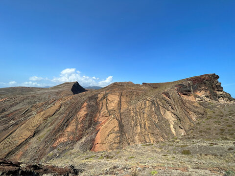 Folded red and ochre volcanic strata on the ridge of the Ponta de Sao Lourenco peninsula, Canical, Madeira, Portugal
