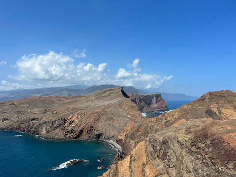 Cumulus clouds over the arid ridge of the Ponta de Sao Lourenco peninsula with the Madeira massif beyond, Canical, Madeira, Portugal