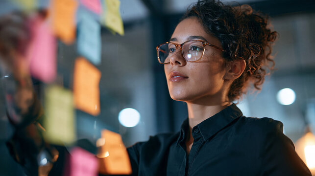 Entrepreneur arranging colorful sticky notes into a swot analysis grid on a glass wall, business strategy, innovation process, with copy space