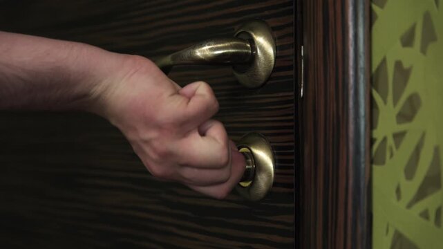 Close-up of a hand opening and closing the door latch