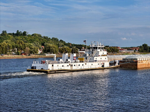 Savanna, Illinois August 16, 2026 The Aaron F. Barrett tugboat navigating South down the Mississippi river pushing a set grain cargo barges