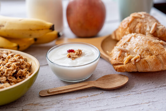Croissant granola and yogurt create an appealing breakfast composition for bakery menus wellness content and casual home dining promotions.