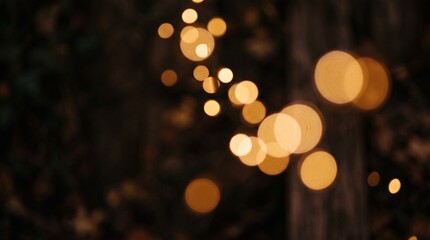 Fototapeta premium Abstract golden bokeh lights forming soft, glowing circles against a dark, blurred background, creating a magical and dreamy atmosphere, perfect for festive overlays or mystical design elements
