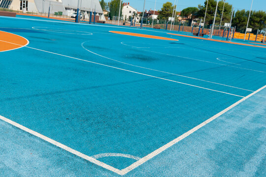 football soccer multipurpose sports court blue orange rubber surface white line markings outdoor futsal basketball field concept of sport, fitness, recreation
